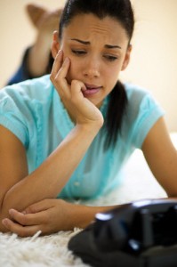 Young Woman Waiting Beside Telephone